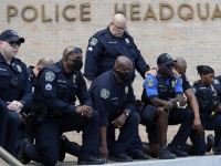 Members of the Austin Police Department kneel in front of demonstrators who gathered in Austin, Texas, Saturday, June 6, 2020
